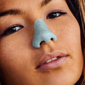 Close up of a Model wearing the shade Seafoam Blue Nöz sunscreen